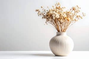 cut and dried flowers in a white vase