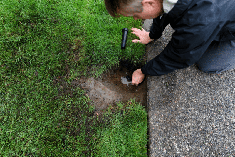 person maintaining a sprinkler system