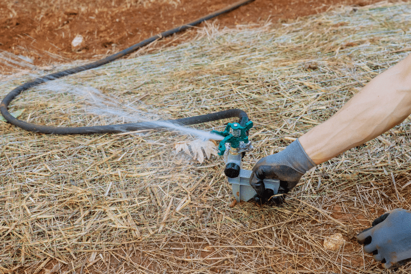 Technician installing sprinkler system following irrigation permit process in Ohio