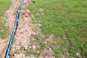 Buried irrigation pipe showing proper installation depth for how deep irrigation pipes should be buried in Ohio