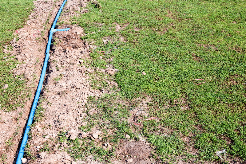 Buried irrigation pipe showing proper installation depth for how deep irrigation pipes should be buried in Ohio